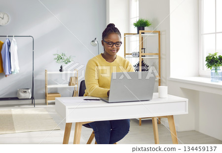 Young african american business woman working with laptop computer at home or at office. 134459137