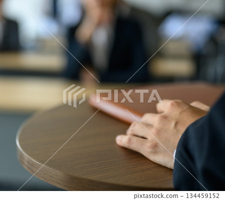 Businessman putting his hand on a document at a meeting 134459152