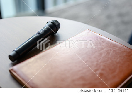 Conference room desk with microphone and notebook Conference room desk with microphone and notebook 134459161