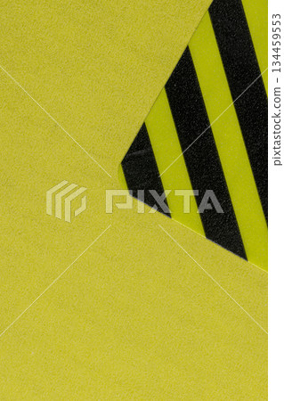 a closed yellow package with a protective sticker against opening and theft, a whole striped sticker to protect the goods from opening, indicating that the box was not opened. 134459553