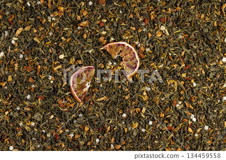 tea with added flavors and pieces of fruit and cut dried red oranges, bright large dry slices of blood red orange close up tea with added flavors and pieces of fruit and cut dried red oranges, bright large dry slices of blood red orange close up 134459558