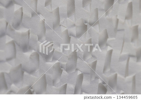 crumpled white paper with a lot of cuts is used for packaging and decorative purposes, white paper with cuts and a lot of holes is used for packaging goods and other purposes crumpled white paper with a lot of cuts is used for packaging and decorative purposes, white paper with cuts and a lot of holes is used for packaging goods and other purposes 134459605