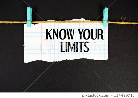 Know Your Limits text written on rip paper with wooden clip on black background Know Your Limits text written on rip paper with wooden clip on black background 134459713
