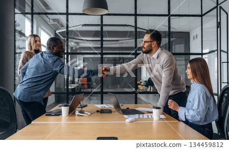 Shaking hands, greetings. Professional workers are in the modern office together 134459812