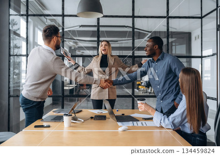 Cooperation, doing handshake. Professional workers are in the modern office together Cooperation, doing handshake. Professional workers are in the modern office together 134459824