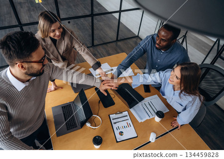 Supporting each other, team is together. Professional workers are in the modern office Supporting each other, team is together. Professional workers are in the modern office 134459828