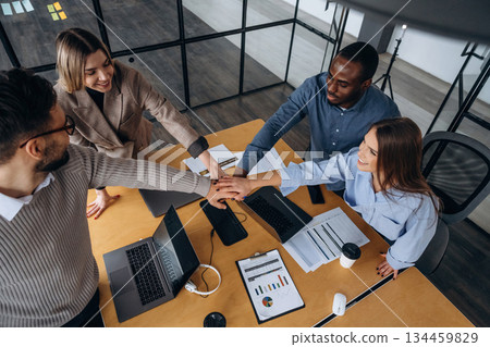 Supporting each other, team is together. Professional workers are in the modern office Supporting each other, team is together. Professional workers are in the modern office 134459829