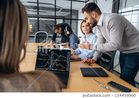 Active discussion and planning. Professional workers are in the modern office together 134459900