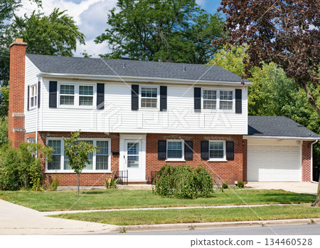 Suburb exterior with private housing. Suburban neighborhood. Private family home architecture. House exterior. Private house in suburban area. Suburban house architecture. Residential privacy 134460528