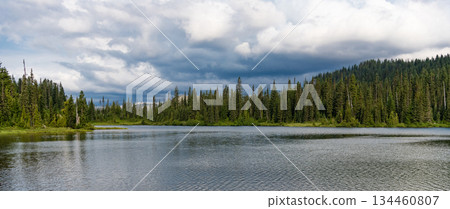 Lake with mountain landscape. Landscape of mountain and forest of lake. Nature landscape. Lake in scenic nature. Scenic nature of popular hiking lake. Mountain forest. Green forest. Wide horizon 134460807