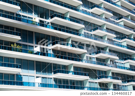 Glass building design. Architectural detail. Background of architecture. Modern residential background. Glass background. Architecture. Building architecture. Building background with balconies Glass building design. Architectural detail. Background of architecture. Modern residential background. Glass background. Architecture. Building architecture. Building background with balconies 134460817