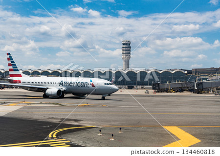 Washington DC, USA - June 04, 2024: American airline plane departure or arrival in airport terminal on runway strip Washington DC, USA - June 04, 2024: American airline plane departure or arrival in airport terminal on runway strip 134460818