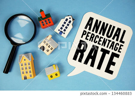 APR Annual Percentage Rate text with house models on blue background APR Annual Percentage Rate text with house models on blue background 134460883