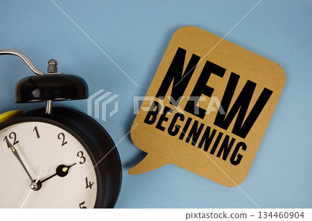 New Beginning text with alarm clock on blue background New Beginning text with alarm clock on blue background 134460904