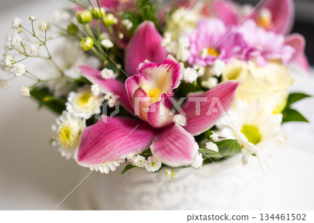 Close-up of vibrant orchid and daisies. Harmony of colors, natural beauty, and delicate floral texture. Close-up of vibrant orchid and daisies. Harmony of colors, natural beauty, and delicate floral texture. 134461502