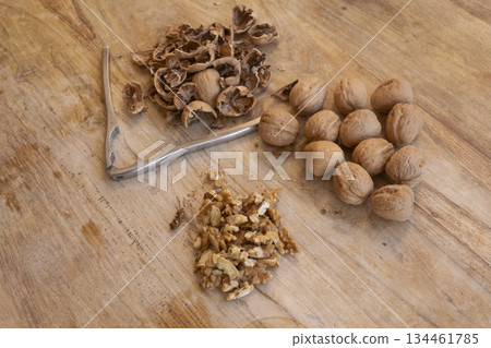 walnuts on rustic wooden table with nutcracker walnuts on rustic wooden table with nutcracker 134461785