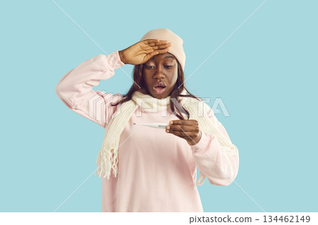 Frustrated African american woman looking surprised at pregnancy test in worry, upset with result Frustrated African american woman looking surprised at pregnancy test in worry, upset with result 134462149