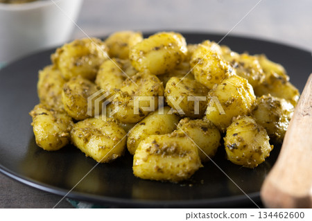 Gnocchi with pesto sauce served on black plate Gnocchi with pesto sauce served on black plate 134462600