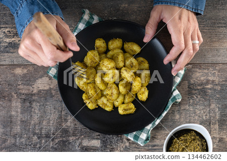 Woman eating gnocchi with pesto sauce Woman eating gnocchi with pesto sauce 134462602