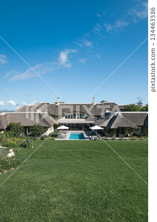 Beautiful luxury resort with swimming pool and green lawn, summer vacation Beautiful luxury resort with swimming pool and green lawn, summer vacation 134463586