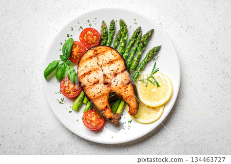 Grilled salmon fish steak with asparagus, tomatoes and lemon slices Grilled salmon fish steak with asparagus, tomatoes and lemon slices 134463727