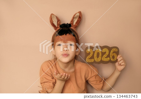 A beautiful girl dressed up as a horse blows a kiss, welcoming the new year 2026. Waiting for miracles A beautiful girl dressed up as a horse blows a kiss, welcoming the new year 2026. Waiting for miracles 134463743