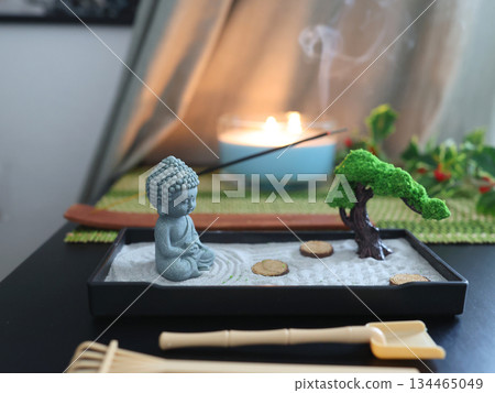 Zen style Buddha statue. Miniature meditation and relaxation set for home on table with incense stick on stand. Eastern rock garden. Zen style Buddha statue. Miniature meditation and relaxation set for home on table with incense stick on stand. Eastern rock garden. 134465049