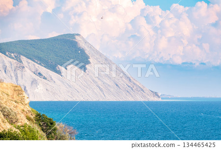 High mountain slopes to the Black Sea coast in Anapa, Russia. Coastline in sunset, beautiful sea scenery. Anapa coast landscape, high cliff High mountain slopes to the Black Sea coast in Anapa, Russia. Coastline in sunset, beautiful sea scenery. Anapa coast landscape, high cliff 134465425