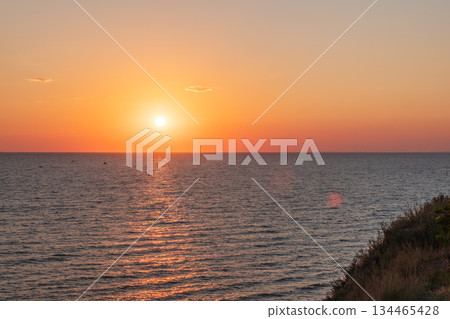 Beautiful red and orange sunrise over the sea. Beautiful red and orange sunrise over the sea. 134465428