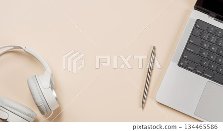 Laptop and stationery on beige workspace, top view with copy space 134465586