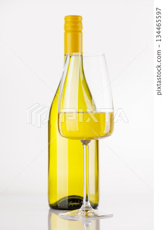 White wine bottle and glass on white background 134465597