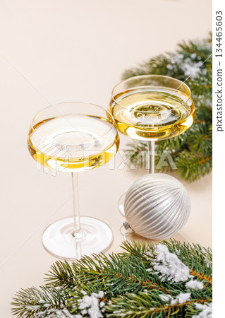 Champagne glasses and snowy fir branches Champagne glasses and snowy fir branches 134465603