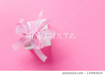 Gift box with pink bow on pink background Gift box with pink bow on pink background 134465624