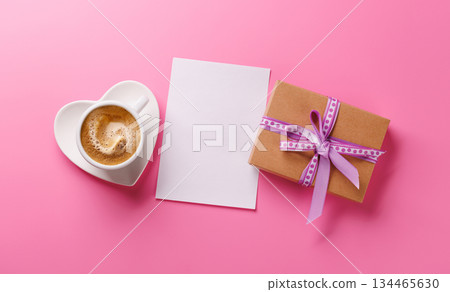 A romantic Valentines Day setup featuring a gift box and a steaming cup of coffee A romantic Valentines Day setup featuring a gift box and a steaming cup of coffee 134465630