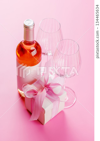 Gift box and wine glasses on pink background 134465634