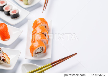 Assorted sushi and maki rolls beautifully arranged on plates 134465637