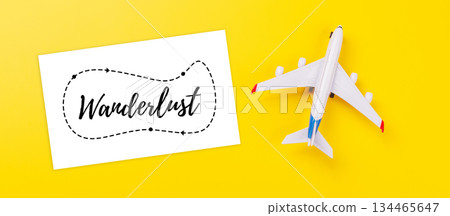 Travel-themed flat lay with card and toy airplane Travel-themed flat lay with card and toy airplane 134465647
