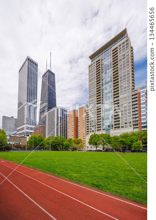 Green sports field with running track in Chicago residential area Green sports field with running track in Chicago residential area 134465656