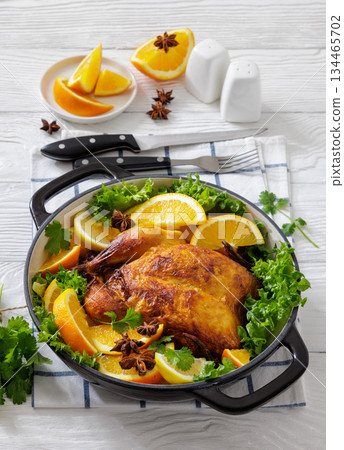 Whole roasted chicken in baking dish with citrus Whole roasted chicken in baking dish with citrus 134465702