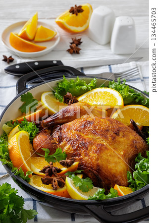 Whole roasted chicken in baking dish with citrus Whole roasted chicken in baking dish with citrus 134465703