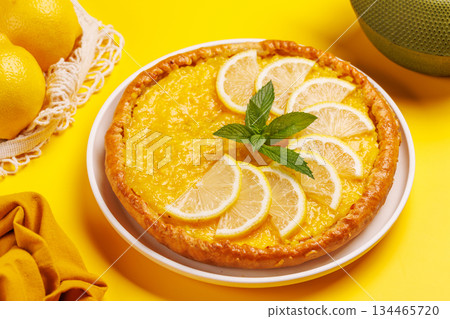 Delicious lemon tart with golden crust and smooth, glossy lemon filling 134465720
