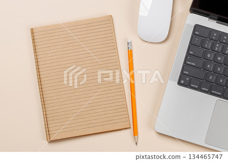 Blank notepad, laptop and stationery on beige workspace, top view with copy space Blank notepad, laptop and stationery on beige workspace, top view with copy space 134465747