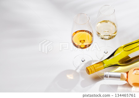 Different wine bottles and glasses on white background 134465761