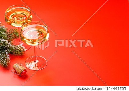 Champagne glasses and snowy fir branches 134465765