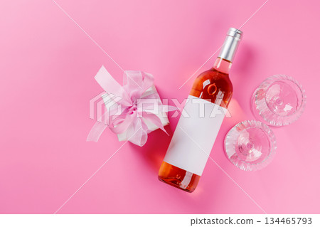 Gift box and wine glasses on pink background 134465793