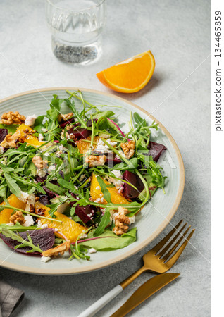 A fresh salad of beets, orange, and arugula with feta, walnuts, and balsamic dressing A fresh salad of beets, orange, and arugula with feta, walnuts, and balsamic dressing 134465859