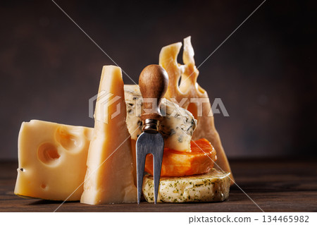 Assorted cheeses in different shapes and textures displayed together Assorted cheeses in different shapes and textures displayed together 134465982