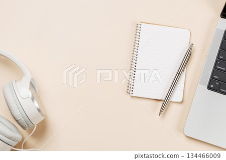 Laptop and stationery on beige workspace, top view with copy space 134466009