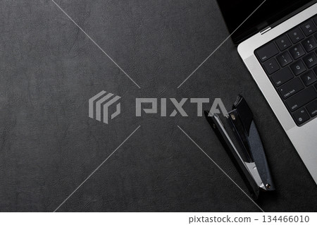 Office supplies and laptop on black leather workspace, top view with copy space Office supplies and laptop on black leather workspace, top view with copy space 134466010