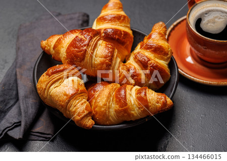 Aromatic croissants in bowl with cup of coffee 134466015